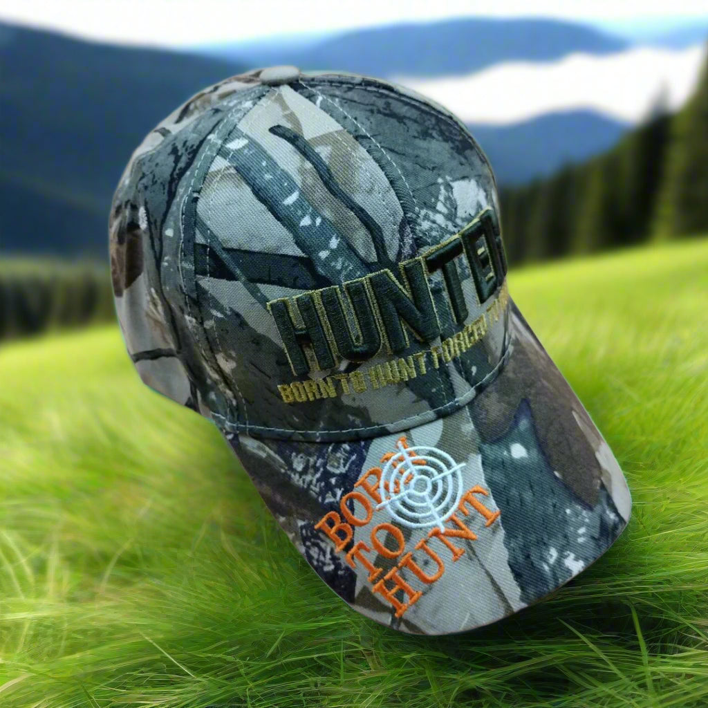 Camouflage cap with 'HUNTER' and 'Born to Hunt Forever' text on a beige background