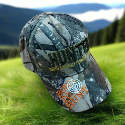 Camouflage cap with 'HUNTER' and 'Born to Hunt Forever' text on a beige background