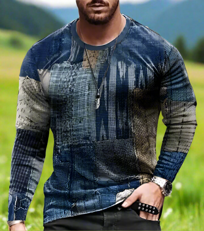 A man wearing a long sleeve men's shirt with a 3D geometric pattern in blue and khaki colors.