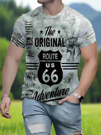 A person wearing a white crew neck T-shirt with text 'The Original Route US 66 Adventure' printed on the front.