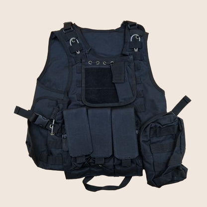 Black tactical vest with multiple pockets and straps on a green background