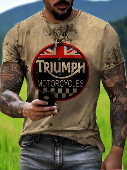 A person wearing a short-sleeved beige T-shirt with a Triumph Motorcycles logo on it, against a white background.