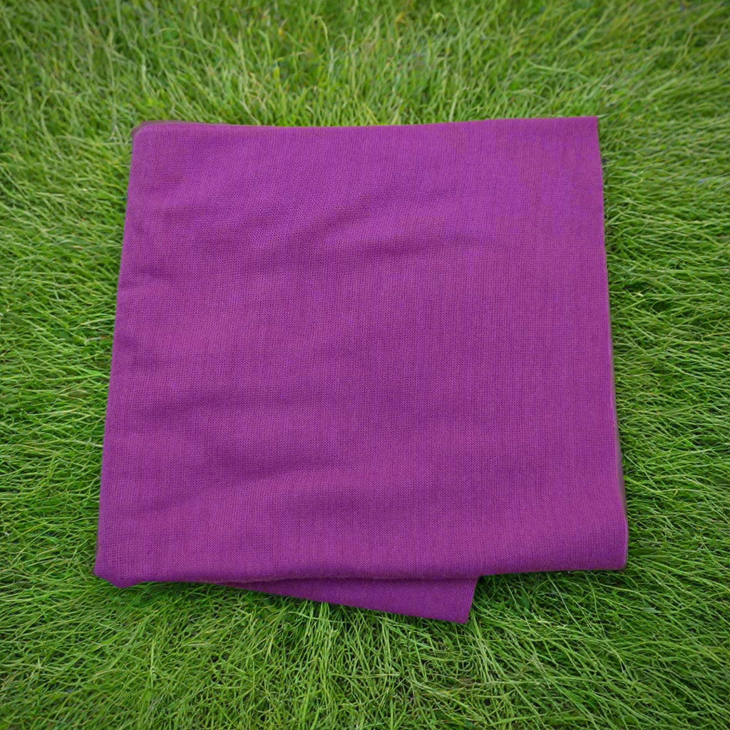 Purple towel on green grass