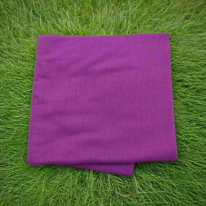 Purple towel on green grass
