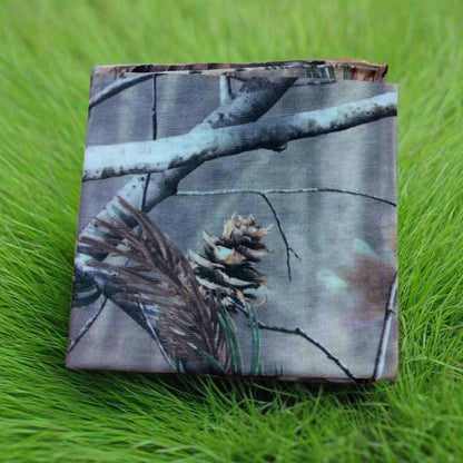 A folded camouflage patterned fabric on a plain background, likely intended for use in clothing accessories such as arm sleeves or beanies.