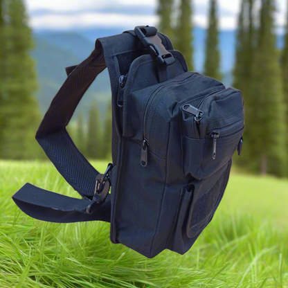 A black crossover bag with multiple compartments and zipper closures. It has adjustable straps and appears to be made of canvas material.