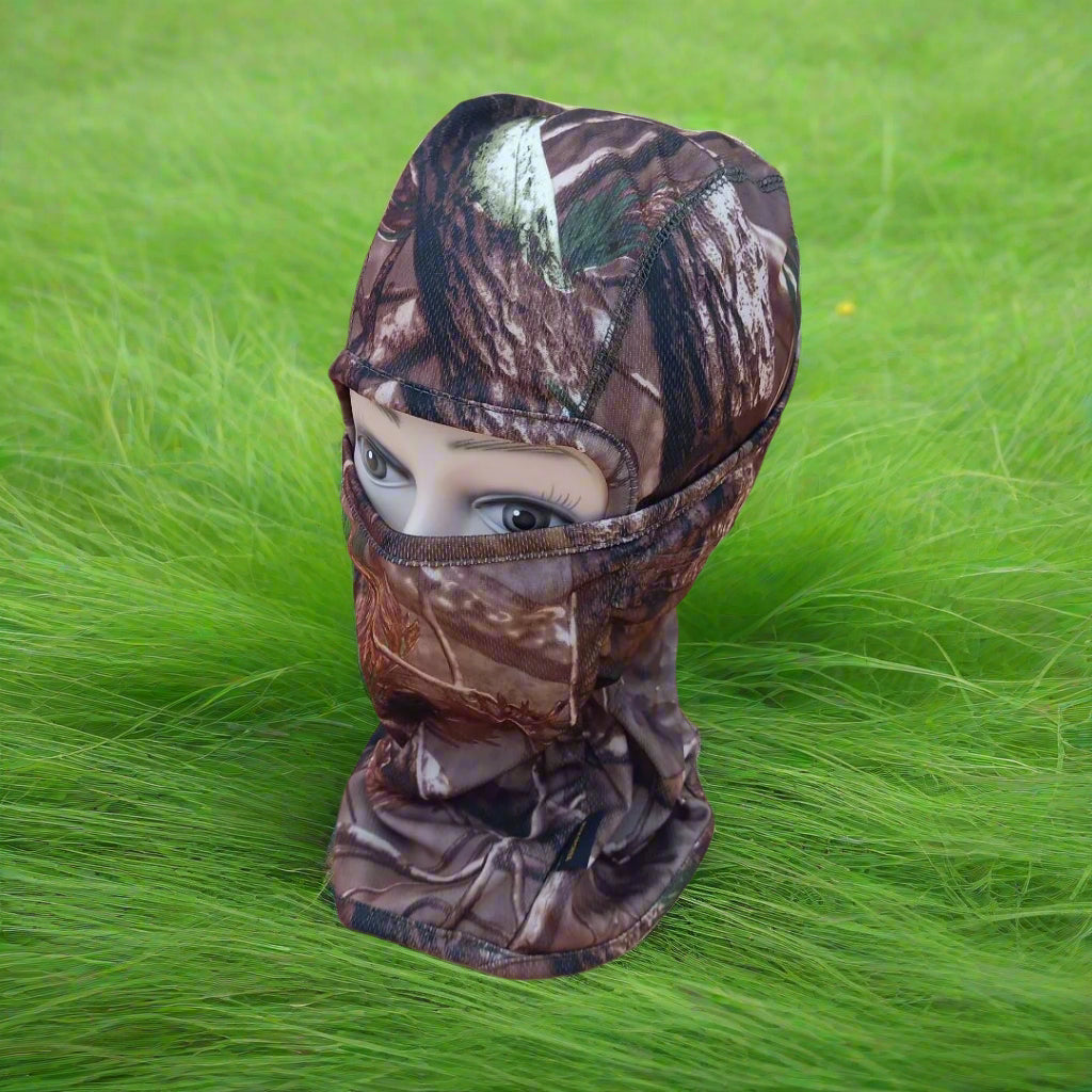 A person wearing a camouflage patterned full face mask covering.