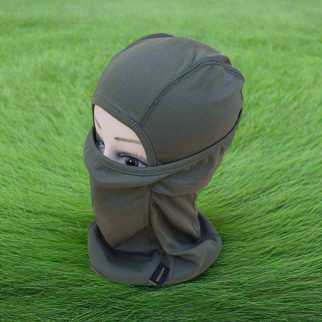 A person wearing a green full face mask covering.