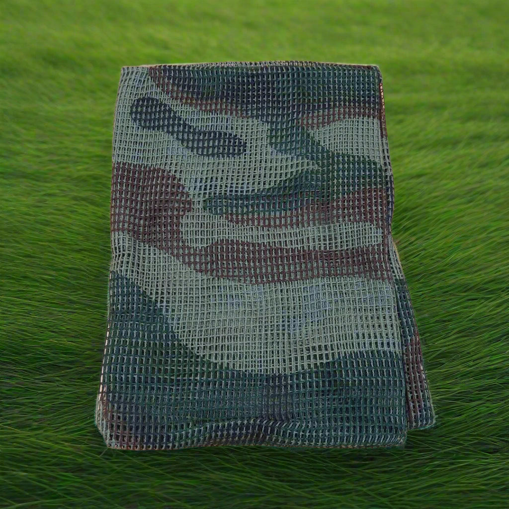 Folded camouflage-patterned fabric on a beige background