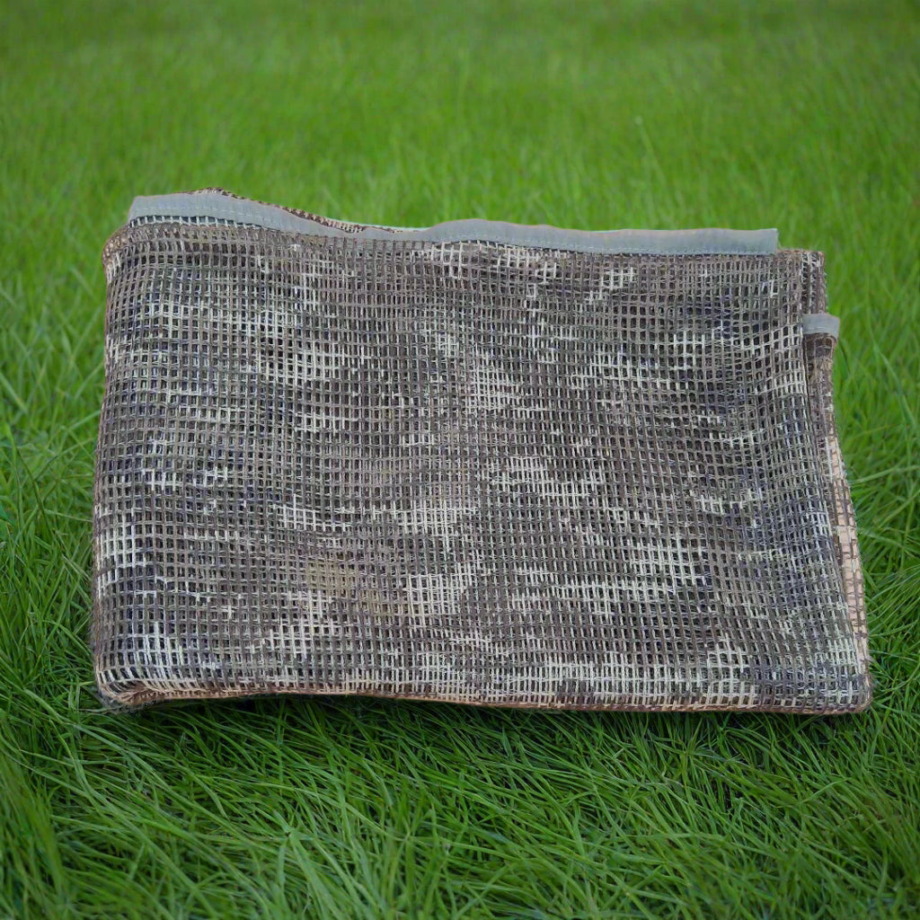 Folded metallic mesh pouch on a beige background