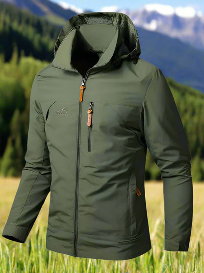 A green soft-shell jacket with a removable hoodie, long sleeves, and a hooded collar. The jacket is zipperpered and appears to be lightweight with space for pockets or branding on the chest area.