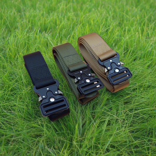 Three tactical belts with buckles on a grass background