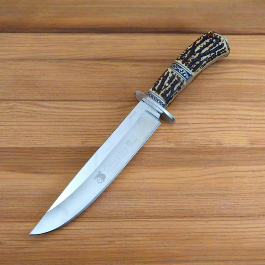Decorative knife with a wooden handle on a wooden surface