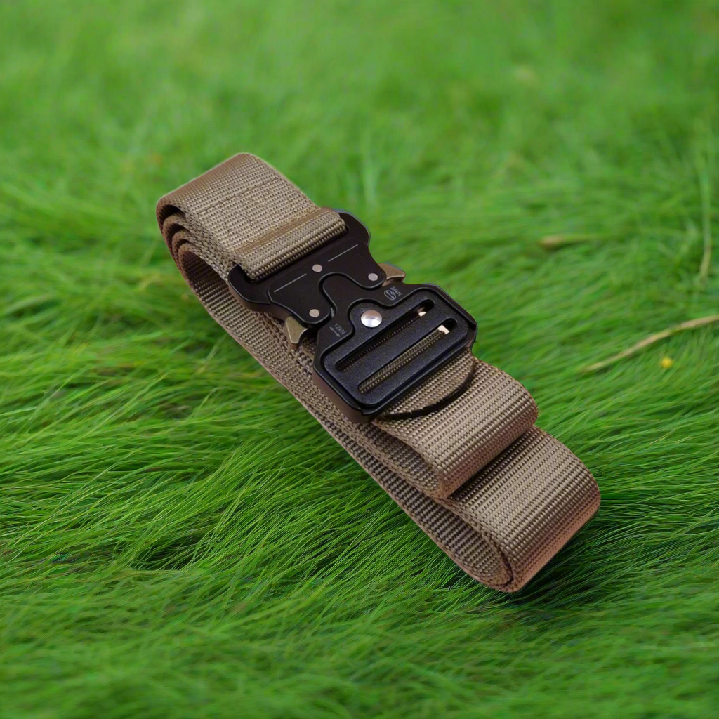 Khaki tactical belt with a black buckle on green grass