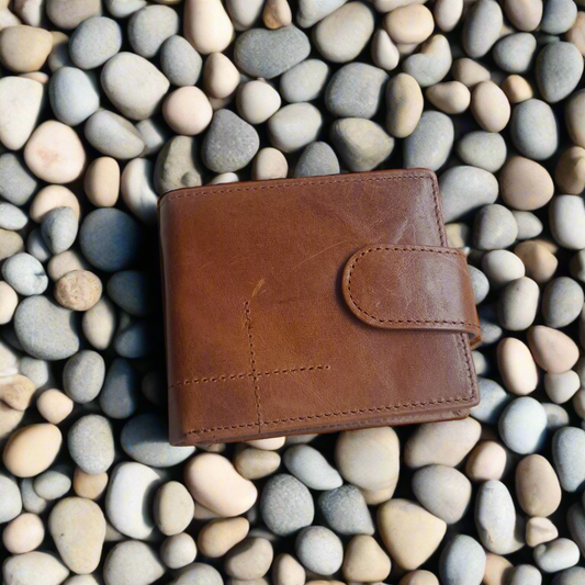 Brown leather wallet on a bed of pebbles