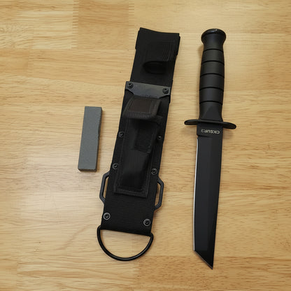 Black knife with sheath on a wooden surface