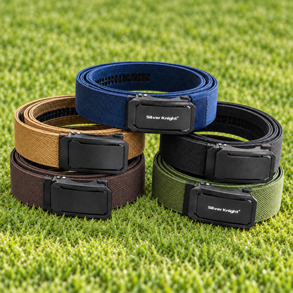Four adjustable web belt dog collars in blue, tan, black, brown, and green, arranged in a pyramid on a green grass background. Each collar has a black quick-release buckle with the Silver Knights brand logo.