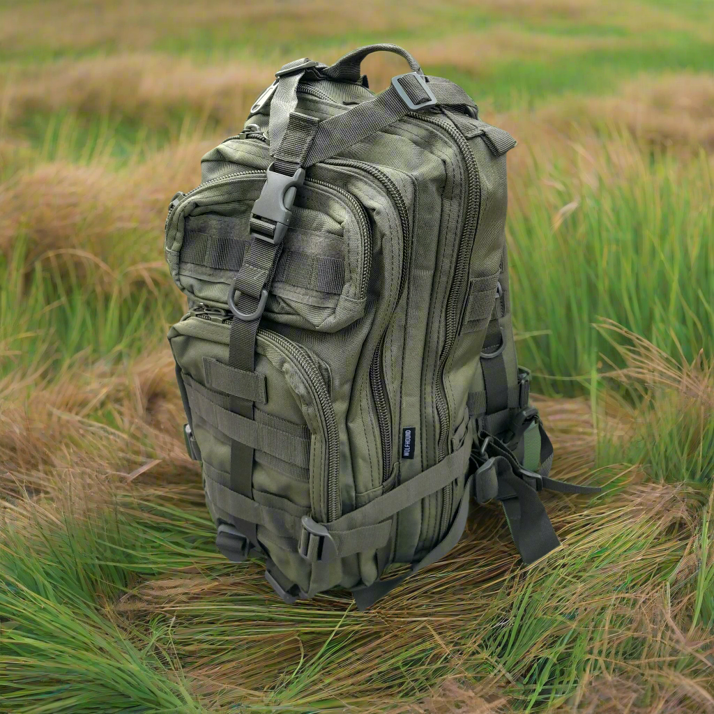 Green tactical backpack in a grassy field