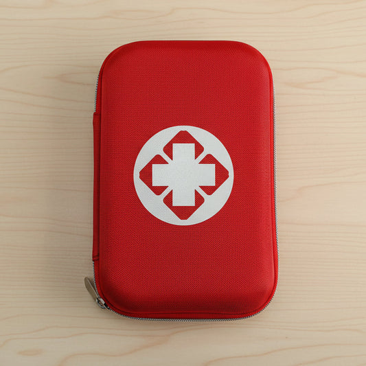 Red first aid kit with a white cross symbol on a light gray background