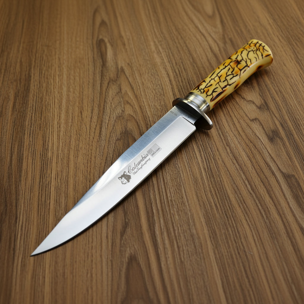 Knife with a decorative handle on a white surface