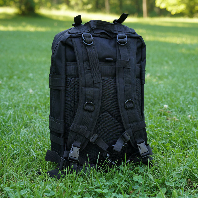 Black backpack on a light gray surface with a wooden background