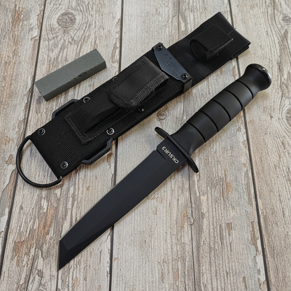 Black knife with sheath on a wooden surface