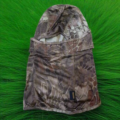 A person wearing a camouflage patterned full face mask covering.