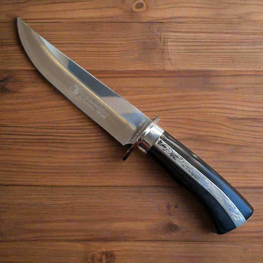 Knife with a black handle on a wooden surface