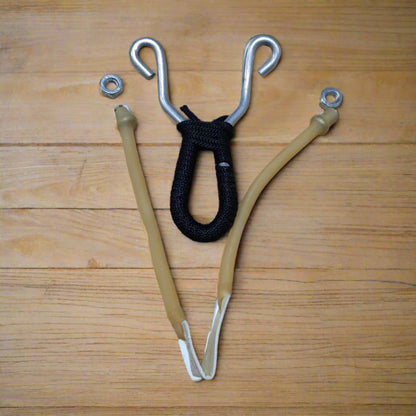 A slingshot with a metal frame and a black grip