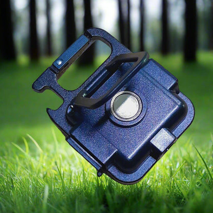 Blue metal tool on grass with blurred trees in the background