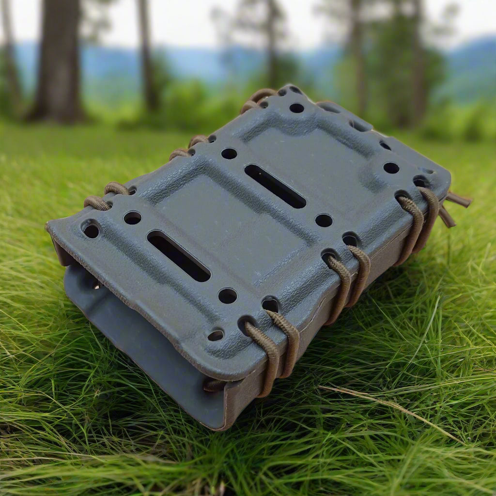 A green kydex  adjustable magazine pouch for AR/AK style rifles.